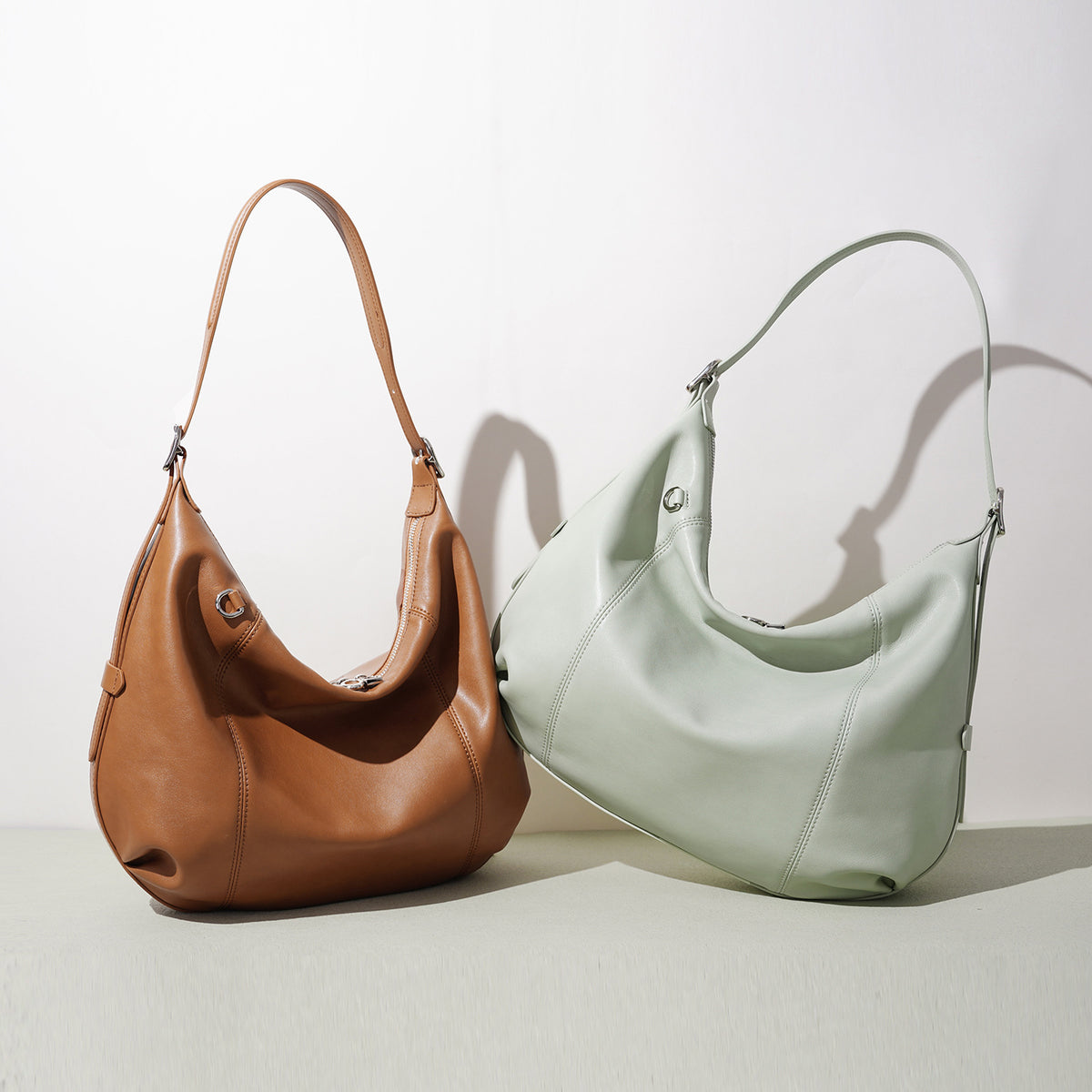 Brown and sage green Soft Crescent hobo bags side by side